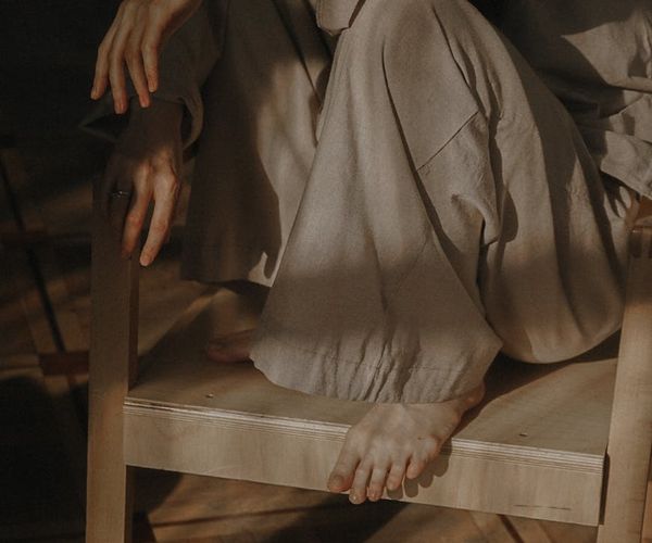 A serene person meditating in a quiet, minimalist room.